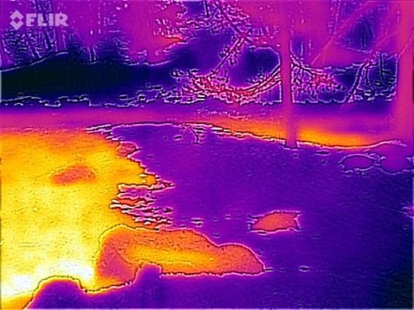 The cold purple patches are snow; the warm yellow patches are bare ground.